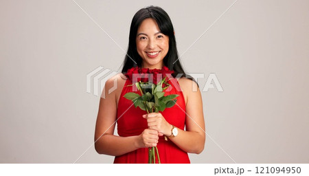 Woman, studio background and smile with rose on portrait for love, care and valentines day celebration in Japan. Japanese person, romance and happy in red dress with flower as anniversary gift 121094950