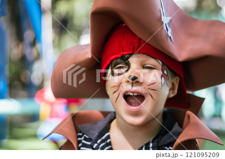 Boy Cat Pirate costume. Halloween party in kindergarten. Aqua makeup painted kids face. Bright festive Boy Cat Pirate costume. Halloween party in kindergarten. Aqua makeup painted kids face. Bright festive 121095209