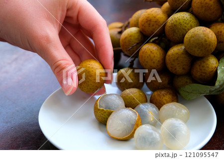longan fruit on a white round plate isolate on white background 121095547