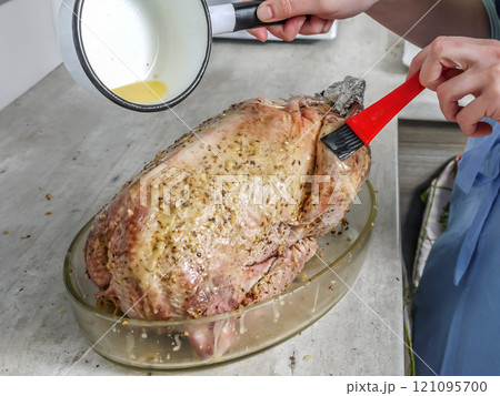 Raw goose being prepared for roasting 121095700
