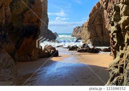 Empty wild sandy beach, Atlantic Ocean seascape, sea waves, beautiful cloudscape, dramatic landscape, travel content, Lisbon, Portugal 121096552