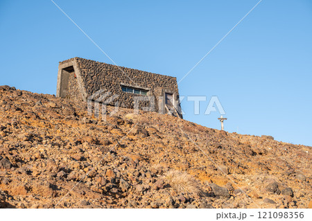Zao mountain Yamagata Japan, Lava stone house on a barren landscape under blue sky. 121098356