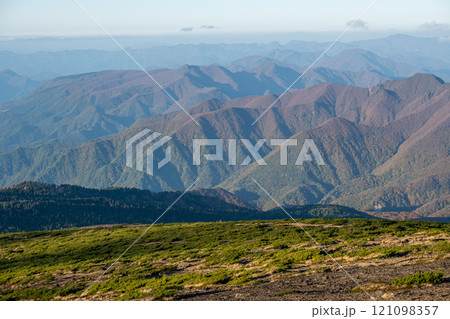 Zao mountain Yamagata Japan, Mountainous landscape under clear skies and distant peaks 121098357