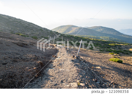 Zao mountain Yamagata Japan, Scenic mountain trail with distant hills and clear sky. 121098358