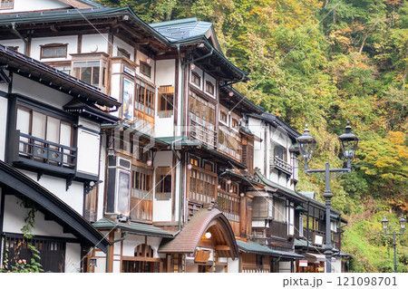 Ginzan onsen, Yamagata, Japan, Traditional wooden building in a scenic forest setting. Ginzan onsen, Yamagata, Japan, Traditional wooden building in a scenic forest setting. 121098701