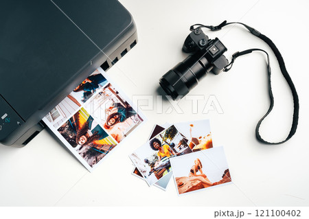 Printer and photo camera on table. Printing photos concept Printer and photo camera on table. Printing photos concept 121100402