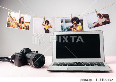 Laptop and camera on the table close up. Printing photos Laptop and camera on the table close up. Printing photos 121100432