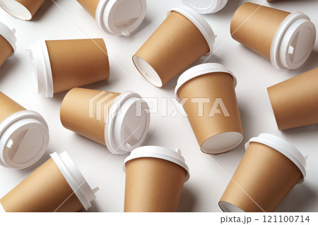A collection of disposable coffee cups arranged artfully on a white surface A collection of disposable coffee cups arranged artfully on a white surface 121100714