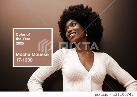 Woman showcases elegance and joy in a cozy, neutral-toned setting with mocha mousse color trend for 2025 121100745