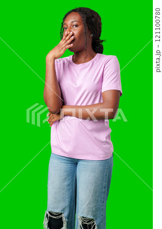Woman expressing surprise and excitement on a bright green background 121100780