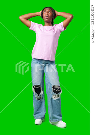 Woman expressing surprise and excitement on a bright green background Woman expressing surprise and excitement on a bright green background 121100817