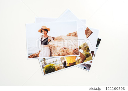 Printed colorful photos of women portraits against gray background 121100898