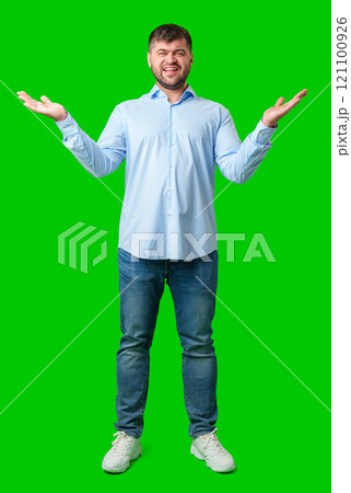 A man playfully posing with a quirky expression against a bright green background A man playfully posing with a quirky expression against a bright green background 121100926