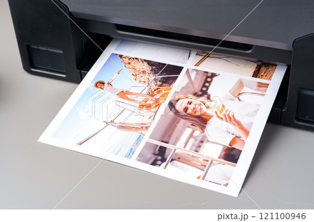 Modern laser printer printing color photos of women close up 121100946