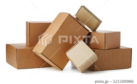 Stacked brown cardboard boxes in various sizes arranged on a white background Stacked brown cardboard boxes in various sizes arranged on a white background 121100966