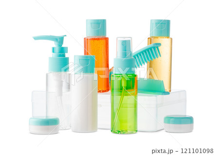 Variety of colorful personal care bottles and grooming accessories arranged on a white surface Variety of colorful personal care bottles and grooming accessories arranged on a white surface 121101098