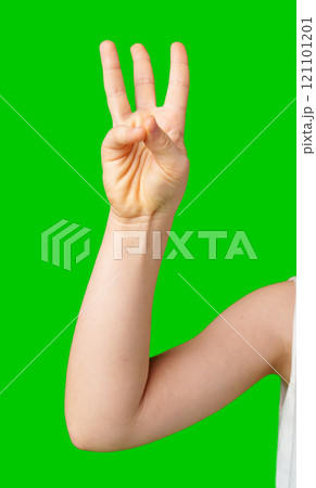A hand showing the number three against a bright green background A hand showing the number three against a bright green background 121101201