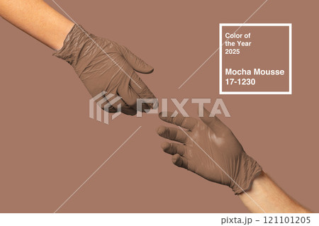 Hands wearing mocha mousse gloves represent the color of the year 2025 in a creative and artistic display Hands wearing mocha mousse gloves represent the color of the year 2025 in a creative and artistic display 121101205