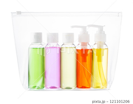 A clear travel pouch filled with vibrant toiletry bottles isolated on white 121101206