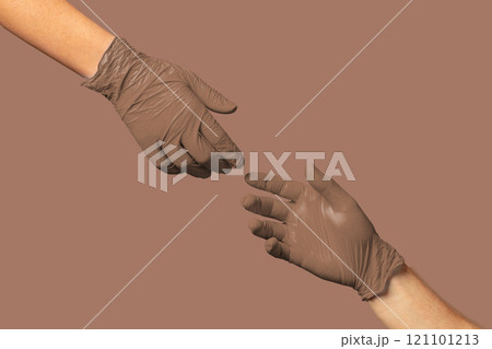 Hands in brown gloves exchanging an object against a neutral background, symbolizing cooperation and assistance 121101213