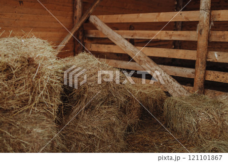 Hay bales stacked in old wooden barn on historic cattle ranch Hay bales stacked in old wooden barn on historic cattle ranch 121101867