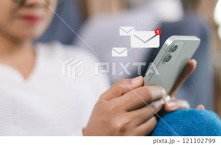 Online communication, online marketing, Data link tech, Woman holding smartphone and touching with virtual icon white newsletter for electronic mail or E-mail with notification alert. Online communication, online marketing, Data link tech, Woman holding smartphone and touching with virtual icon white newsletter for electronic mail or E-mail with notification alert. 121102799