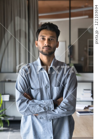 Indian businessman dressed in blue shirt posing at modern workplace 121103694