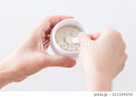 保湿のハンドクリームを塗ってスキンケアをするミドル〜シニア女性の手元 121104350