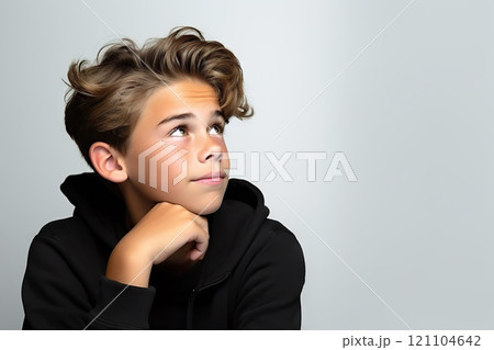 Contemplative Teen Portrait of an Attractive Thinking Boy in Pensive Pose, Isolated on White Background. Teenager Reflecting, Hand on Chin, Thoughtful Expression, Deep in Question. created with 121104642