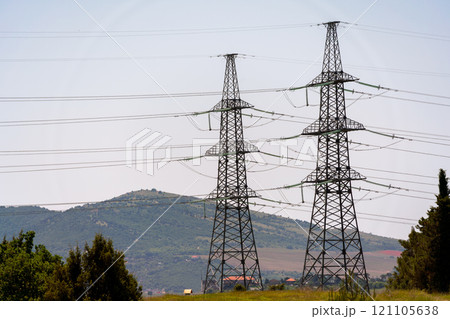 High voltage towers Electric pole. Power line support with wires for electricity transmission. High voltage grid tower with wire cable at distribution station. Energy industry, energy saving 121105638