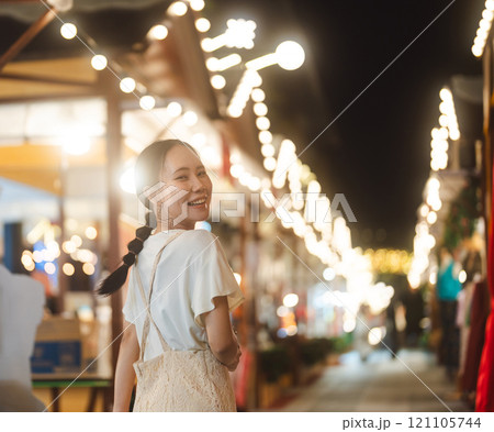 Asian woman walking at outdoors market on Christmas and happy new year holidays Asian woman walking at outdoors market on Christmas and happy new year holidays 121105744