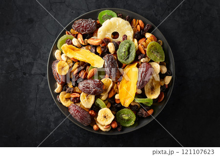Dried tropical fruits with various nuts and raisins. 121107623