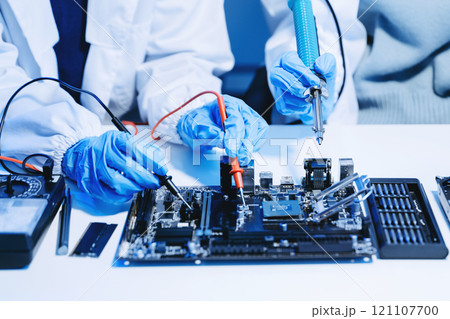 The technician is putting the CPU on the socket of the computer motherboard. electronic engineering electronic repair, electronics measuring 121107700