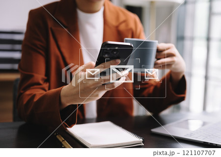 Woman hands using Laptop, tablet typing on keyboard and surfing the internet with email icon, email marketing concept, send e-mail or newsletter, online working internet network 121107707