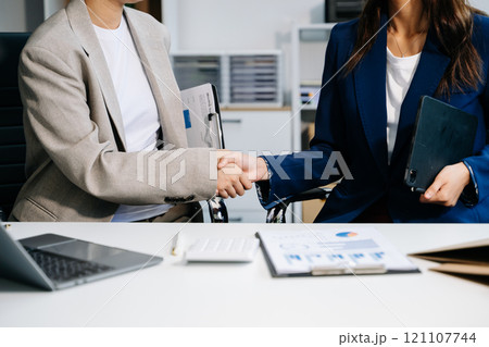Two confident business man shaking hands during a meeting in the office, success, dealing, greeting and partner 121107744