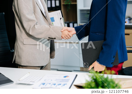 Two confident business man shaking hands during a meeting in the office, success, dealing, greeting and partner Two confident business man shaking hands during a meeting in the office, success, dealing, greeting and partner 121107746