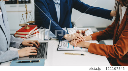 Two lawyers are discussing about contract paper, law matters determination, pointing.law and hammer on the table Two lawyers are discussing about contract paper, law matters determination, pointing.law and hammer on the table 121107843