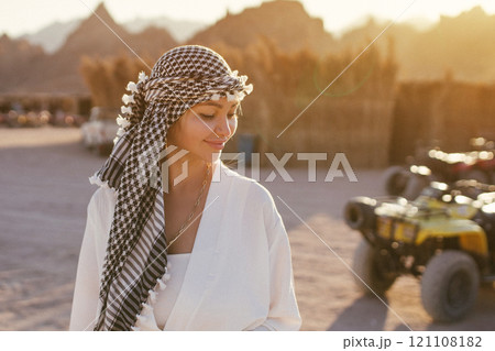 Portrait of a beautiful girl in the desert of Egypt on safari in arabic clothes Portrait of a beautiful girl in the desert of Egypt on safari in arabic clothes 121108182