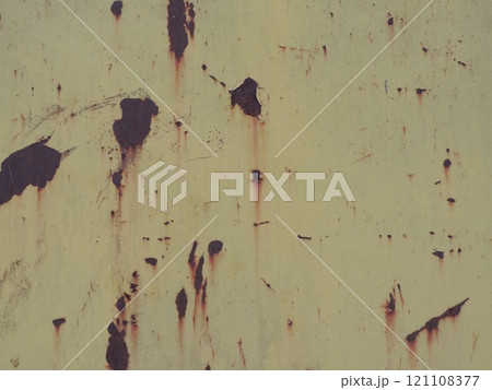 scratches and peeling paint on a worn iron surface, rough rusty painted background with empty copy space 121108377