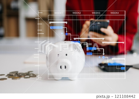 Women are putting coins in a piggy bank for a business that grows for profit and saving money for the future. Women are putting coins in a piggy bank for a business that grows for profit and saving money for the future. 121108442