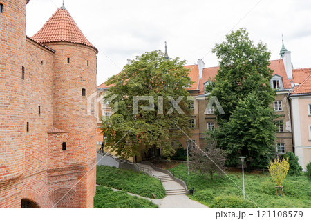 Barbacan castle and its fortification walls and structures. The streets of the old city. The sights of the Polish capital Warsaw. Barbacan castle and its fortification walls and structures. The streets of the old city. The sights of the Polish capital Warsaw. 121108579