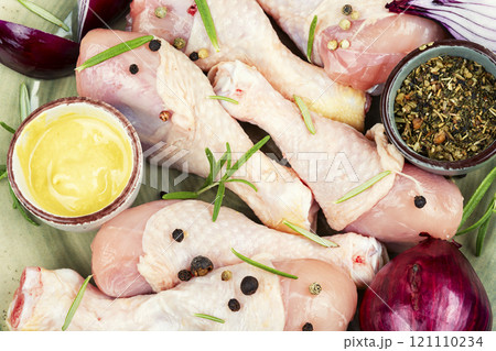 Raw chicken leg pieces with spices. Raw chicken leg pieces with spices. 121110234