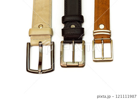 Three leather belts lie on a white background 121111987