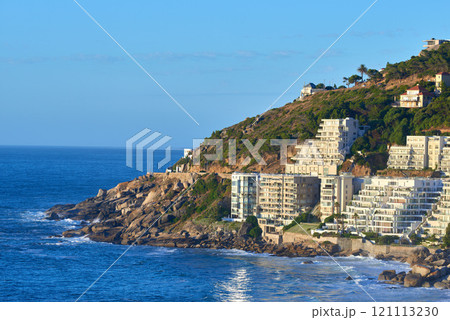 Clifton, Cape Town, South Africa panorama seascape with clear blue sky, hotels, and apartment buildings in the background. Housing development overlooking the beautiful blue ocean peninsula 121113230