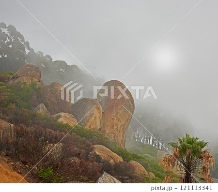 A misty morning on peaceful mountain peak, quiet zen nature with scenic views. Smog covered rocky landscape of Lions Head mountain. The aftermath of a devastating wildfire on a mountain. 121113341