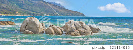 Ocean seascape of Camps Bay beach, Table Mountain National Park, Cape Town, South Africa. Calm scenic sea landscape with rocks and waves on a blue horizon. Stunning turquoise water by a coastline Ocean seascape of Camps Bay beach, Table Mountain National Park, Cape Town, South Africa. Calm scenic sea landscape with rocks and waves on a blue horizon. Stunning turquoise water by a coastline 121114016