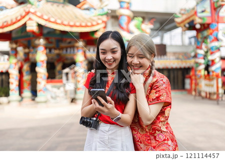 Celebrating chinese new year worship at the shrine festivities in a vibrant setting joyful friends cultural experience Celebrating chinese new year worship at the shrine festivities in a vibrant setting joyful friends cultural experience 121114457