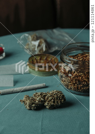 spliff, cannabis bud and rolling tobacco on table spliff, cannabis bud and rolling tobacco on table 121114861