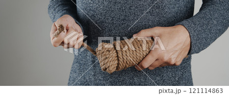 pulls on the loose end of a coil of rope, banner pulls on the loose end of a coil of rope, banner 121114863