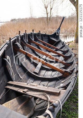 Detailed view of the interior of a Viking longboat, highlighting wooden ribs, ropes, and traditional construction techniques 121115175
